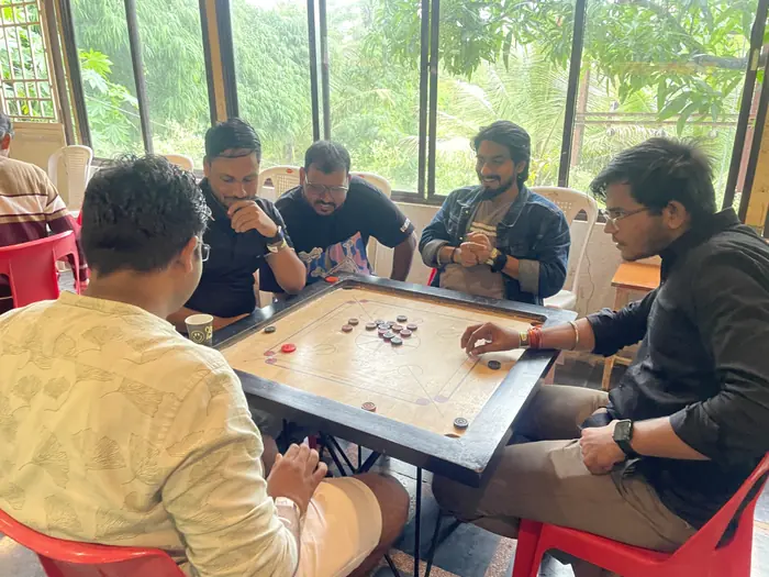 Barquecon Technologies colleagues playing carrom during a team outing