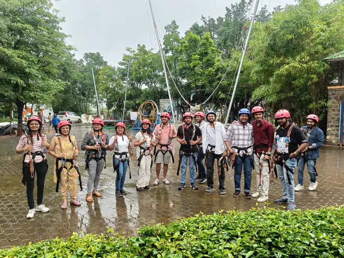 Barquecon Technologies team in harnesses and helmets at an adventure park outing