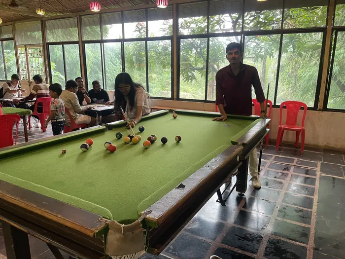 Barquecon Technologies colleagues playing pool during a team outing