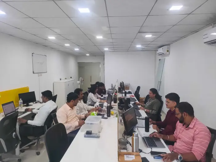 Barquecon Technologies developers working at their desks in the office
